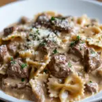 inesboulila A close up of creamy beef and bowtie pasta served o c83ab535 648c 4015 ba88 8574cf6d452c