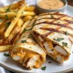 inesboulila A plate of cheesy garlic chicken wraps golden brown d6e725b7 cf40 4e55 86c3 696694cf1026