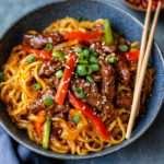 inesboulila A vibrant bowl of sticky beef noodles featuring ten 565cbcb0 8ada 45f3 bacf c07ae196f120