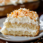 inesboulila A close up shot of a slice of creamy coconut cake r c7816678 d6a5 435e 8c75 0a0efbffa5dd