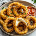 inesboulila A plate of golden crispy baked onion rings each per 712160fa e163 4716 b964 16f88b68f0dc